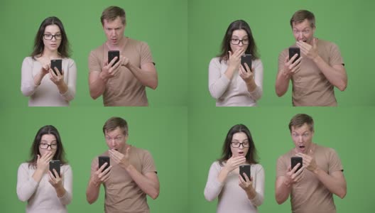 年轻夫妇使用电话和看起来震惊在一起高清在线视频素材下载