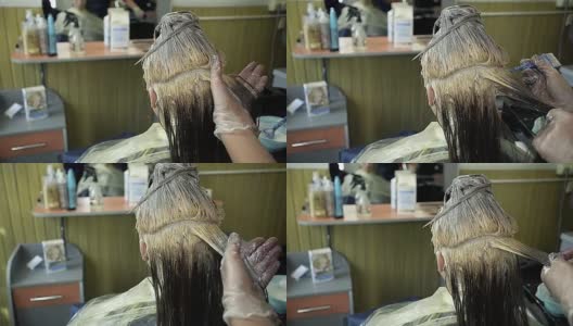 一个年轻女孩在美容院头发上的抽象画高清在线视频素材下载