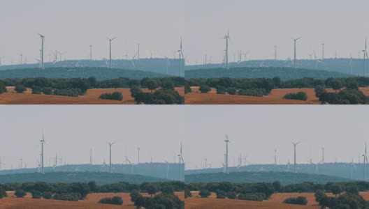 风车发电技术，绿色技术，清洁和可再生能源解决方案，美丽的风车涡轮机利用清洁，绿色，风能在西班牙的油田高清在线视频素材下载