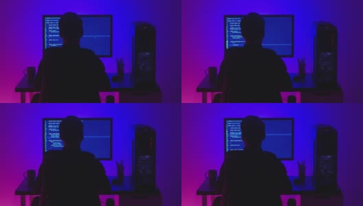 后视图男子程序员编码网络安全软件在霓虹灯在夜间室内。黑客在黑暗的办公室电脑屏幕上键入代码高清在线视频素材下载