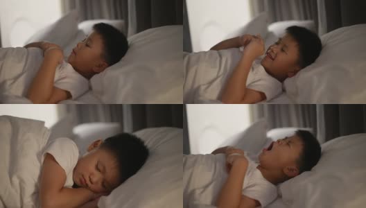亚洲小孩穿着睡衣睡觉。梦想的概念高清在线视频素材下载