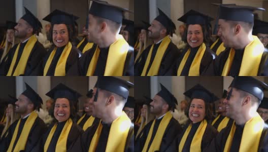 快乐的研究生在毕业典礼上互相交谈高清在线视频素材下载