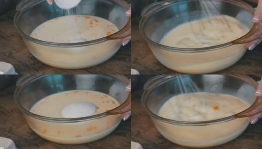 将一杯糖倒进牛奶里做面团。甜蜜的家庭烘焙高清在线视频素材下载