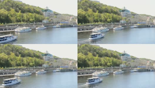 乌克兰基辅——2021年4月24日:一艘游艇沿着河流驶向内河港口。一艘载着游客的船漂浮在一条宽阔的河上。从岸上看水路运输。高清在线视频素材下载
