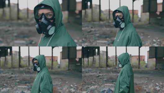 环境污染和生物危害。一个戴防毒面具的人在废弃建筑附近高清在线视频素材下载