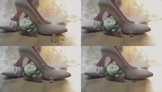 两个结婚戒指在新娘的结婚鞋附近滚动高清在线视频素材下载
