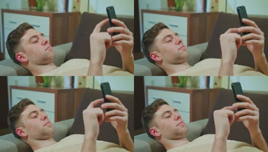 躺在沙发上玩手机的男人高清在线视频素材下载