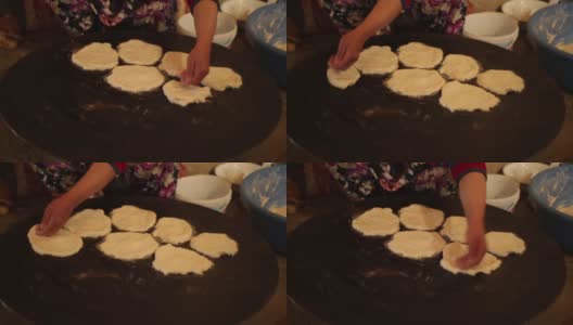安纳托利亚的妇女正在烹饪坑里做安纳托利亚特有的面包。使用工具;锅、盘、面团、火等。乔鲁姆/土耳其01/12/2016高清在线视频素材下载