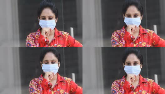 一名妇女戴着口罩咳嗽高清在线视频素材下载