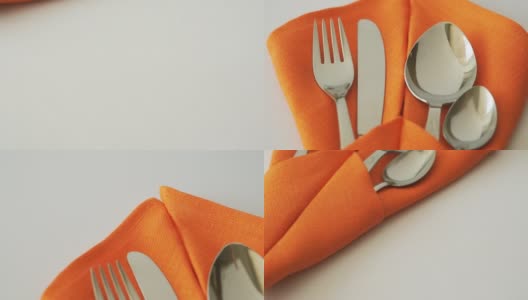 餐具。餐桌上的餐巾里有叉、刀、匙和茶匙高清在线视频素材下载