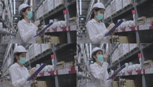仓库工人或亚洲妇女快乐劳动佩戴医用口罩，防止冠状病毒和PM2.5粉尘。在运输行业工作时要戴安全帽以保护自己。概念的关键员工高清在线视频素材下载