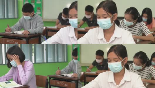 亚洲小学生戴上口罩预防病毒上课开始重开。高清在线视频素材下载