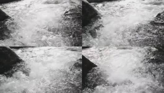 清澈的水飞溅在山间瀑布的岩石中高清在线视频素材下载