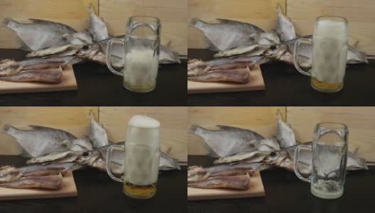 一个盛满啤酒的玻璃杯，背景是鳕鱼高清在线视频素材下载