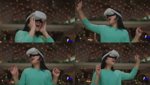 激动人心的亚洲女性穿着vr耳机使用VR-headset眼镜走过metaverse得到体验的虚拟百货商场,亚洲女性享受虚拟现实眼镜虚拟购物高清在线视频素材下载
