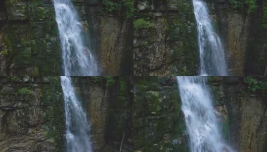 在夏天的热带雨林中，美丽的山河瀑布和白色的泡沫水从岩石悬崖上落下高清在线视频素材下载