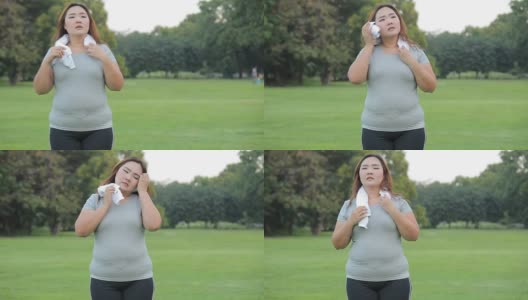 年轻的亚洲胖女人在公园里累了高清在线视频素材下载