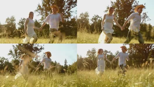 SLO MO TS夫妇牵着手跑过夏季草地高清在线视频素材下载