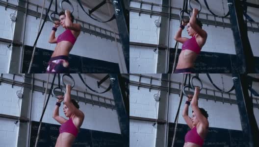 专注的女孩在健身房用吊环锻炼高清在线视频素材下载