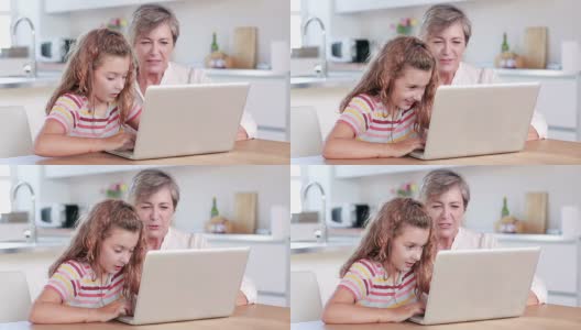 孩子和奶奶一起使用笔记本电脑高清在线视频素材下载