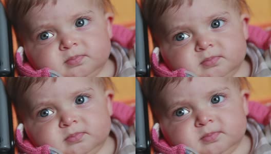一个沉思的婴儿的脸部特写高清在线视频素材下载
