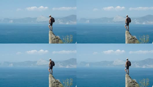 一位游客在悬崖顶上审视着风景高清在线视频素材下载