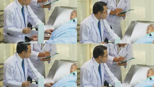 Doctor with stethoscope checking patient's blood pressure of old woman on the bed高清在线视频素材下载