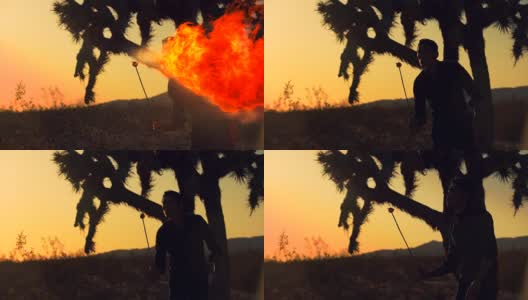 日落时沙漠中吹火的人的慢镜头剪影高清在线视频素材下载