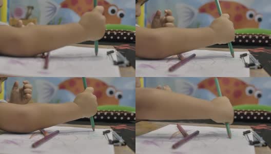 小男孩正在桌子上画画。高清在线视频素材下载