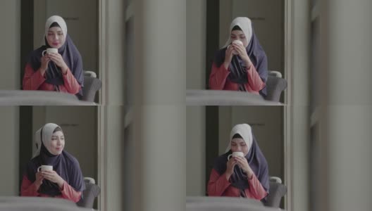 快乐的穆斯林女孩喝茶和微笑在咖啡馆。高清在线视频素材下载