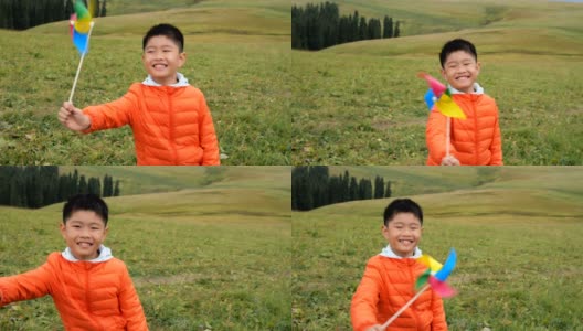 一个亚洲男孩在草原上玩风车高清在线视频素材下载