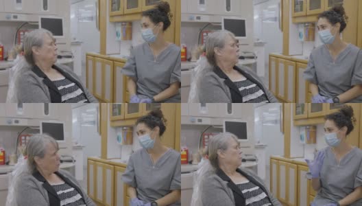 混血牙科保健师与年长的女病人交谈高清在线视频素材下载
