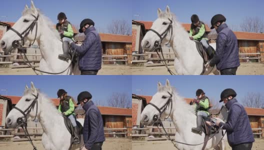 兴奋的女孩，学习如何骑马，同时参观动物救援中心协会高清在线视频素材下载