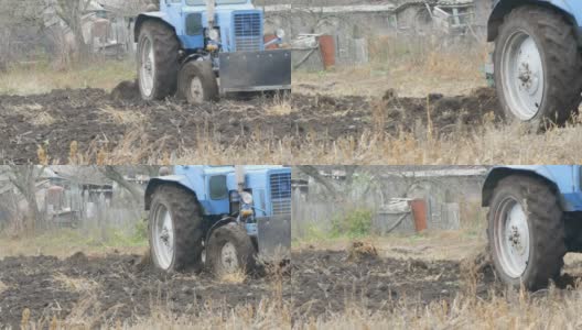 深秋，蓝色的拖拉机在田间犁沟高清在线视频素材下载