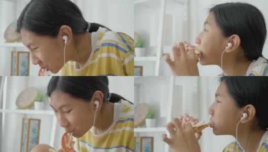 亚洲女孩一边吃着火腿烤面包一边用智能手机看电影，生活理念。高清在线视频素材下载
