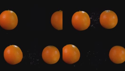 两个橙子在黑色背景上互相碰撞高清在线视频素材下载