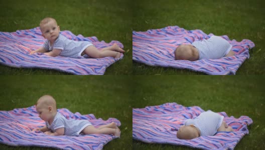 一个可爱的小男孩趴在公园里。高清在线视频素材下载