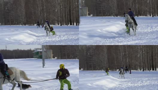 慢镜头:一个女孩骑着马疾驰。一匹马用绳子拖着一个滑雪者。滑雪者在雪堆中骑在滑雪板上。女子骑师和男子滑雪板训练成对。高清在线视频素材下载