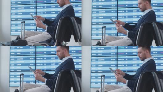 一名男子在机场候机室等候登机时使用平板电脑。高清在线视频素材下载