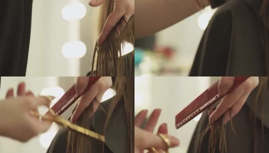 女性手发型师梳理长发，用理发剪刀剪发。近距离的女人美发与专业剪刀在美容院高清在线视频素材下载