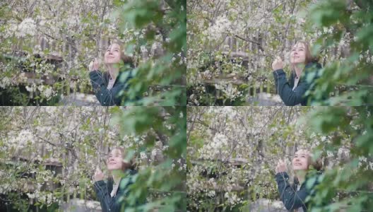 少女花丛中的樱花，花瓣纷纷落下，慢镜头高清在线视频素材下载