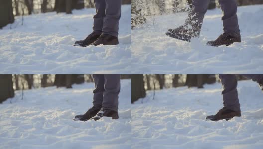 穿着靴子的男子用慢动作踢雪高清在线视频素材下载