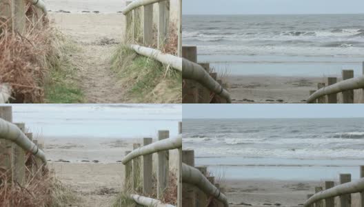 通往宁静的海滩景色的木板路。高清在线视频素材下载