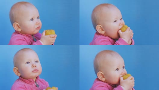 婴儿用双手捧着去皮的梅子吃高清在线视频素材下载