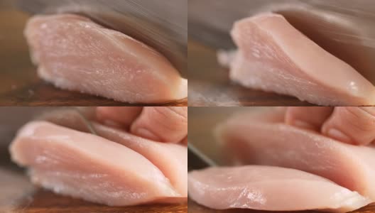 在厨房的木砧板上极近距离切生鸡肉，4K Dci分辨率高清在线视频素材下载