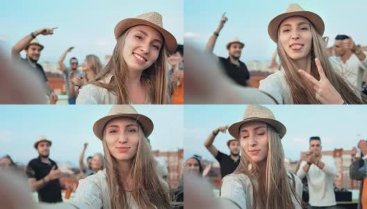 欧洲美女戴着帽子用相机或智能手机自拍夏日屋顶派对高清在线视频素材下载