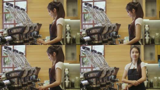 年轻微笑的亚洲女性咖啡师或女性咖啡所有者使用咖啡机，并在咖啡店咖啡厅看着镜头高清在线视频素材下载