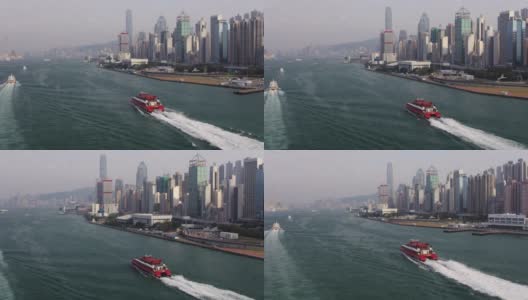 香港航机v44在维多利亚港沿渡轮低空飞行，前往码头，一览城市风光。高清在线视频素材下载