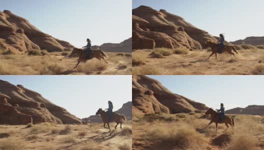 在一个阳光明媚的下午，一个十几岁的美国土著女孩(纳瓦霍人)骑着她的马飞驰在亚利桑那州/犹他州的纪念碑谷沙漠中的慢动作镜头高清在线视频素材下载