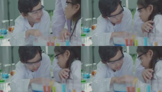 亚洲的孩子在科学实验室里学习，在实验中玩得很开心。使用干冰与水混合产生冷却蒸汽高清在线视频素材下载